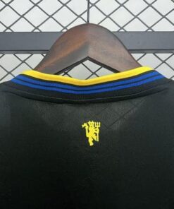 Detail of the Manchester United 2025/2026 third jersey – logo and fabric texture