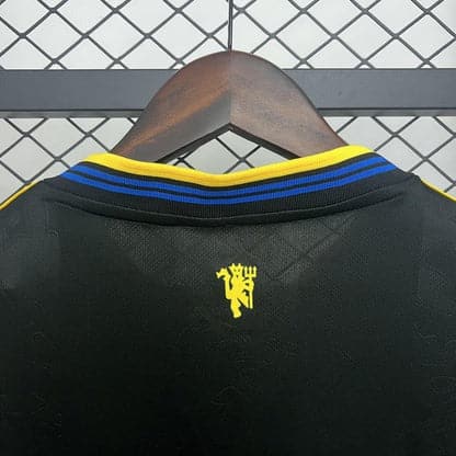 Detail of the Manchester United 2025/2026 third jersey – logo and fabric texture